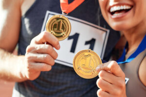 Runner holding a custom 5K finisher medal after completing a charity race